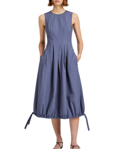 Woman wearing a sleeveless blue dress on a white background