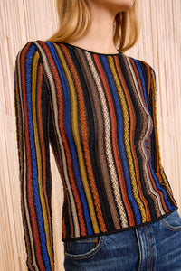 Multicolored striped sweater worn by a person against a neutral background