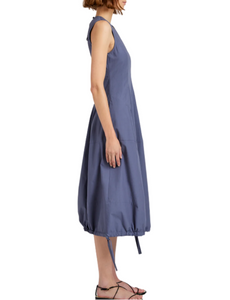 Woman wearing a sleeveless blue dress on a white background